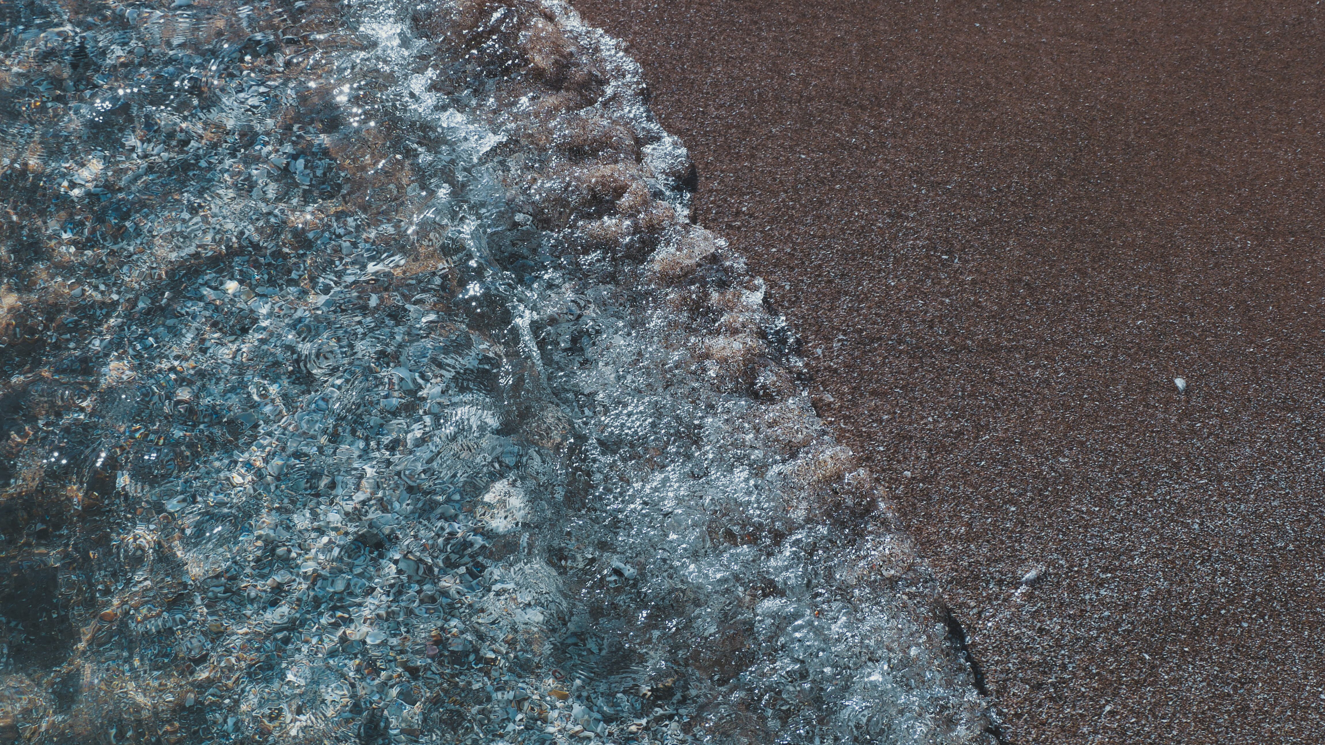 Close-up where ocean water meets sandy beach